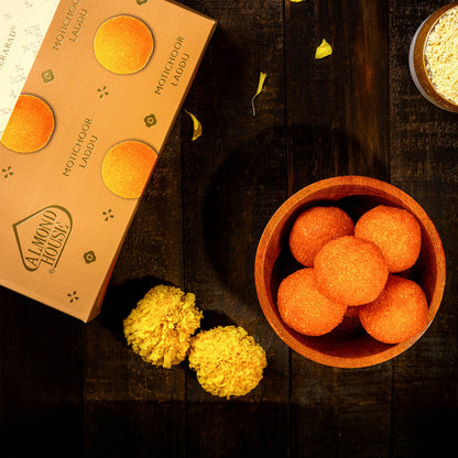 Almond House Motichoor Laddu in a bowl beside the Almond House gift box