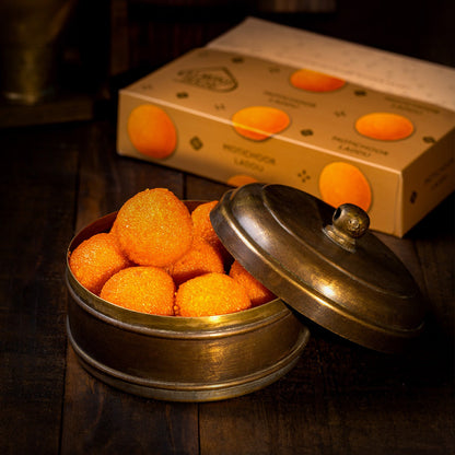 Almond House Motichoor Laddu in a brass tin with the Almond House box